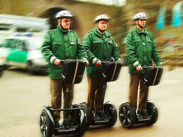 three police officers on segway personal transporters